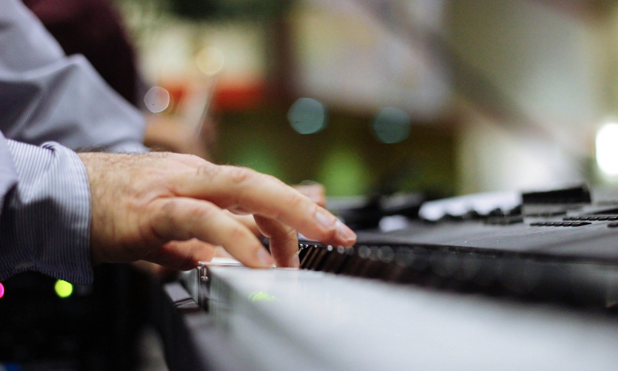 Selective focus of person composing on a piano